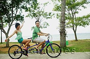 Asia Images Group - Couple cycling on tandem bicycle