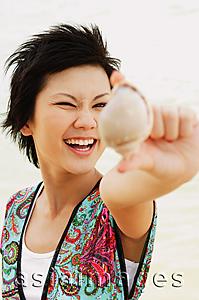 Asia Images Group - Woman holding shell