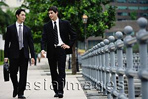 Asia Images Group - Two businessmen walking side by side, talking