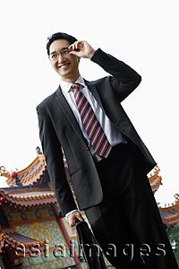 Asia Images Group - Businessman with briefcase, smiling