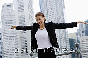 Asia Images Group - Businesswoman with arms outstretched, looking at camera, smiling