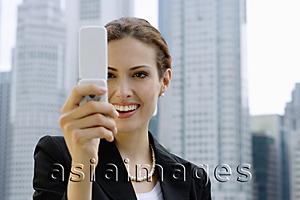 Asia Images Group - Businesswoman using mobile phone, photo messaging