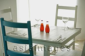 Asia Images Group - Table and chairs in restaurant with two bottled drinks on table