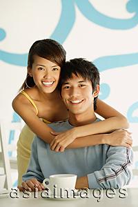 Asia Images Group - Woman embracing seated man, portrait