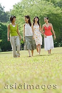 Asia Images Group - Four young women walking side by side in park