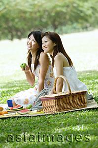 Asia Images Group - Two young women picnicking in park