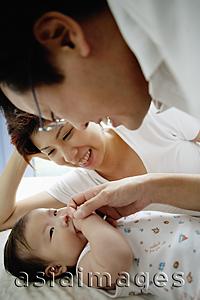 Asia Images Group - Father and mother looking at baby girl