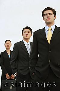 Asia Images Group - Business people standing in a row, looking away