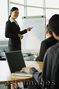 Asia Images Group - Businesswoman presenting to colleagues