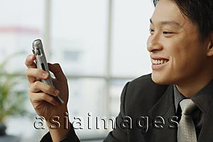 Asia Images Group - Businessman looking at mobile phone