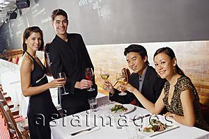 Asia Images Group - Couples in restaurant, holding wine glasses, smiling at camera
