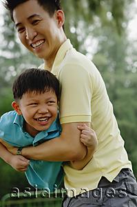 Asia Images Group - Father carrying son, both smiling