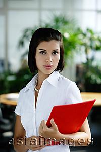 Asia Images Group - Female executive carrying clipboard, looking at camera