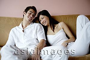 Asia Images Group - Couple on sofa, looking at camera