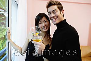 Asia Images Group - Couple with wine glasses, smiling at camera