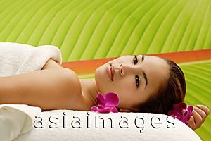 Asia Images Group - Young woman lying on massage table