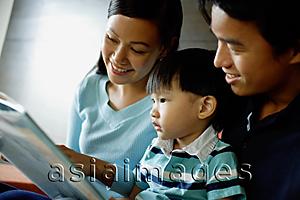 Asia Images Group - Family with one child reading a book