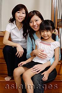 Asia Images Group - Three generations of females, sitting in stairs, looking at camera
