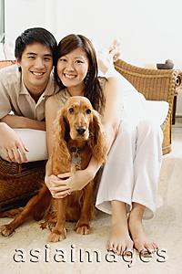 Asia Images Group - Couple in living room, with Cocker Spaniel dog