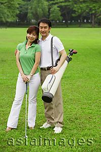 Asia Images Group - Couple on golf course, looking at camera