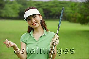 Asia Images Group - Female golfer smiling at camera