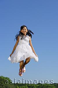 Asia Images Group - Girl wearing white dress, jumping in mid air