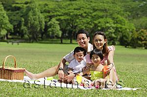 Asia Images Group - Family of four having a picnic, looking at camera