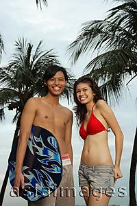 Asia Images Group - Couple in beach wear, looking at camera