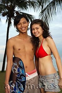 Asia Images Group - Couple at the beach, looking at camera