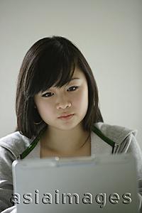 Asia Images Group - Young woman looking at laptop