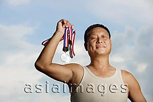 Asia Images Group - Mature adult in tank top, holding medals