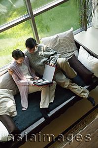 Asia Images Group - Couple at home looking a photo album, high angle view
