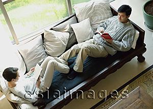Asia Images Group - Couple at home, reading