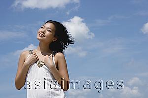 Asia Images Group - Woman in white top, smiling, looking away