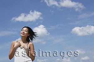 Asia Images Group - Woman in white top, smiling, eyes closed
