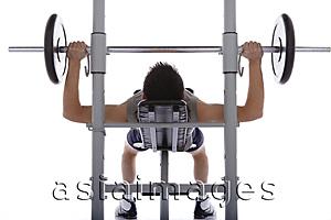 Asia Images Group - Young man lifting weights