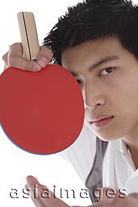 Asia Images Group - Young man with table tennis paddle, looking at camera