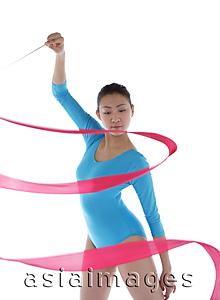 Asia Images Group - Woman holding ribbon, performing rhythmic gymnastics