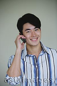 Asia Images Group - Young man using mobile phone
