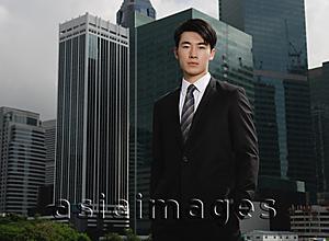 Asia Images Group - Businessman looking at camera, buildings in the background