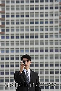 Asia Images Group - Businessman looking through camera phone