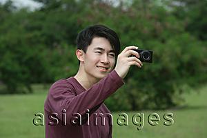 Asia Images Group - Man taking a picture with camera