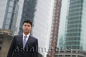 Asia Images Group - Businessman looking at camera, city location