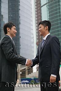 Asia Images Group - Businessmen in the city, shaking hands