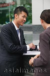 Asia Images Group - Businessman and businesswoman having a discussion