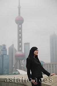 Asia Images Group - Woman looking away, Oriental Pearl TV Tower in the background