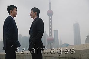 Asia Images Group - Businessmen talking, Oriental Pearl TV Tower in the background