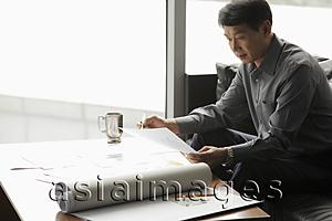 Asia Images Group - Mature man working in an office