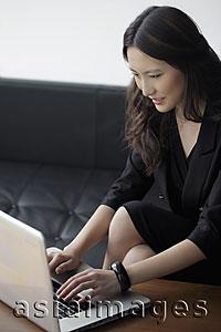 Asia Images Group - Young woman working on a laptop