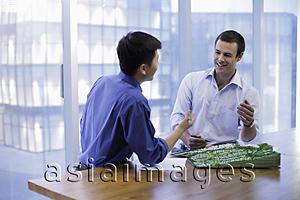 Asia Images Group - Young men having a meeting in modern office